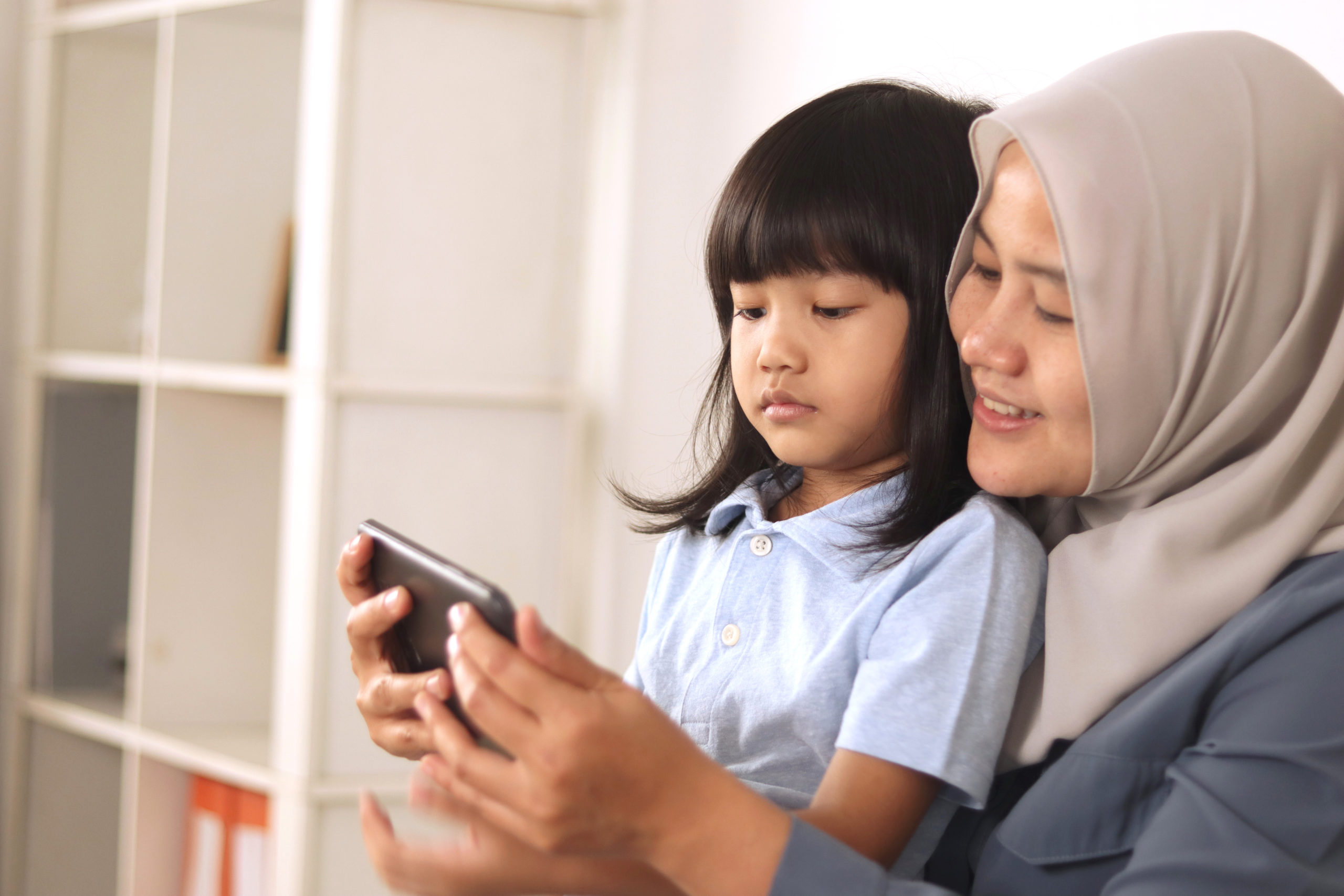 Asian Muslim Mom And Little Baby Girl Daughter Learning Online O