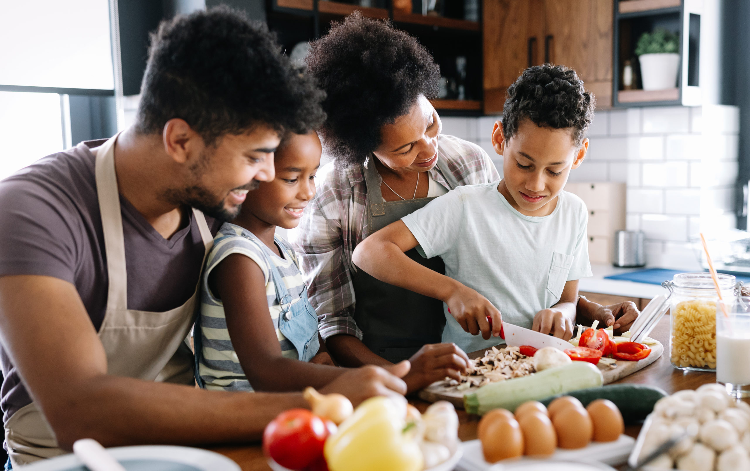 Happy Family In The Kitchen Having Fun And Cooking Together. Hea